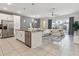 Open-concept kitchen flowing into living area, featuring island and stainless steel appliances at 1632 Tropical Palms Circle, Kissimmee, FL 34747