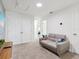 Cozy sitting area featuring neutral carpet, comfortable seating, and access to additional rooms at 1632 Tropical Palms Circle, Kissimmee, FL 34747