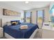 Inviting bedroom features stylish decor, a comfortable bed, and plenty of natural light at 1632 Tropical Palms Circle, Kissimmee, FL 34747