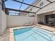 A private screened-in swimming pool with lounge chairs; creating an enjoyable backyard retreat at 1632 Tropical Palms Circle, Kissimmee, FL 34747
