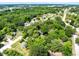 A high angle view of a wooded lot surrounded by mature trees and greenery, presenting a serene and private setting at 1701 E Bay St, Winter Garden, FL 34787