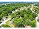 A high angle view of a wooded lot surrounded by mature trees and greenery, presenting a serene and private setting at 1701 E Bay St, Winter Garden, FL 34787