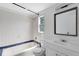 Tiled bathroom with shower, sink, and window, offering plenty of natural light at 1701 E Bay St, Winter Garden, FL 34787