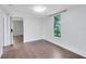 Bedroom featuring hardwood floors, light walls, and natural light streaming through the window at 1701 E Bay St, Winter Garden, FL 34787