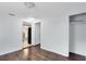 Bedroom featuring hardwood floors, a closet, and access to the kitchen at 1701 E Bay St, Winter Garden, FL 34787