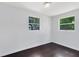 An airy bedroom offers hardwood floors and two windows with views of a green yard at 1701 E Bay St, Winter Garden, FL 34787