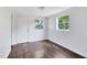 Bedroom featuring hardwood floors and two windows at 1701 E Bay St, Winter Garden, FL 34787