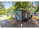 A quaint blue home with a well-maintained exterior, surrounded by trees at 1701 E Bay St, Winter Garden, FL 34787