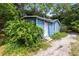 Charming single-story home featuring blue siding and lush greenery at 1701 E Bay St, Winter Garden, FL 34787