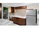 Cozy kitchen with light countertops, tile backsplash, and stainless steel refrigerator at 1701 E Bay St, Winter Garden, FL 34787