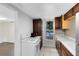 Kitchen with white appliances, wood cabinets, and tile flooring at 1701 E Bay St, Winter Garden, FL 34787