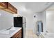 Kitchen featuring light tile flooring, cabinets, and black refrigerator at 1701 E Bay St, Winter Garden, FL 34787