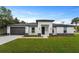 Modern home featuring a black garage door, neutral colors, and dark stone accents at 18743 Overton St, Orlando, FL 32833