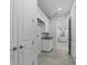 Hallway with utility area with granite countertop, cabinets and modern white trim at 18743 Overton St, Orlando, FL 32833