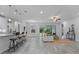 Spacious open-concept living area featuring a kitchen island, seating, and sliding glass doors at 18743 Overton St, Orlando, FL 32833