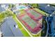 Aerial view of the community tennis courts and building rooftops, and surrounding landscaping at 2216 Stonington Ave # 2216, Orlando, FL 32817