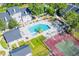 Aerial view of the community pool, tennis courts, landscaping, and multiple buildings at 2216 Stonington Ave # 2216, Orlando, FL 32817