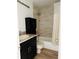 Cozy bathroom with tiled shower, black vanity, and a warm neutral color palette at 2216 Stonington Ave # 2216, Orlando, FL 32817