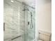 Modern bathroom featuring a glass shower with marble tiles and a handheld shower head at 2216 Stonington Ave # 2216, Orlando, FL 32817