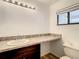 Well-lit bathroom with a modern sink, vanity, and toilet area at 2216 Stonington Ave # 2216, Orlando, FL 32817