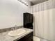 Bathroom featuring vanity with countertop, shower and bathtub combination behind a shower curtain at 2216 Stonington Ave # 2216, Orlando, FL 32817
