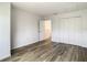 Clean bedroom with wood-look flooring, closet doors, and an entrance way at 2216 Stonington Ave # 2216, Orlando, FL 32817