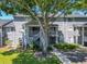 Inviting condo exterior with lush lawn and mature shade tree at 2216 Stonington Ave # 2216, Orlando, FL 32817