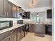 Modern kitchen with dark cabinets and laminate countertops at 2216 Stonington Ave # 2216, Orlando, FL 32817