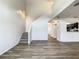 Spacious living room features modern floors, staircase, and view into adjacent kitchen at 2216 Stonington Ave # 2216, Orlando, FL 32817
