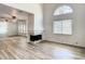 Open living room showcases a fireplace, modern floors, and view into mirrored dining space at 2216 Stonington Ave # 2216, Orlando, FL 32817