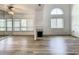Open-concept living room featuring laminate flooring, fireplace, and fan at 2216 Stonington Ave # 2216, Orlando, FL 32817