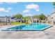 Community pool and lounge area with a clear blue pool, pool furniture and blue skies at 2216 Stonington Ave # 2216, Orlando, FL 32817