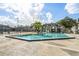 Inviting community pool with clear water, surrounding deck, and nearby condo buildings at 2216 Stonington Ave # 2216, Orlando, FL 32817