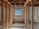 Unfinished bathroom framework showcasing a window, exposed beams, and awaiting a modern design at 2226 Newt St, Orlando, FL 32837