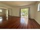 Bright bedroom with hardwood floors and a large sliding glass door at 2349 Oak Park Way # 107, Orlando, FL 32822