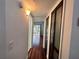 Hallway with hardwood floors that leads to an open and bright living room at 2349 Oak Park Way # 107, Orlando, FL 32822