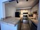 Efficient kitchen featuring stainless steel appliances and functional design at 2349 Oak Park Way # 107, Orlando, FL 32822