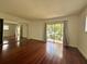 Spacious living room with hardwood floors and large sliding glass door to the outside at 2349 Oak Park Way # 107, Orlando, FL 32822