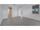 A clean, spacious bedroom with tile flooring, and attached bath and walk-in closet beyond doorway at 2362 Datura Loop, St Cloud, FL 34772