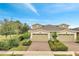 A charming exterior elevation of a two-story home featuring a two-car garage and manicured landscaping at 2362 Datura Loop, St Cloud, FL 34772