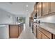 Modern kitchen featuring granite countertops, stainless steel appliances, and a large island at 2362 Datura Loop, St Cloud, FL 34772
