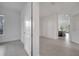 View of living room entry featuring neutral paint, tile floors, and other rooms at 2362 Datura Loop, St Cloud, FL 34772