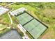 Aerial view of the community tennis courts, swimming pool, and well maintained landscaping at 2362 Datura Loop, St Cloud, FL 34772