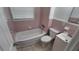 Bathroom featuring pink tile, a shower-tub combo, toilet, and a single sink vanity at 2422 Kingsland Ave, Orlando, FL 32808