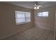 Bedroom with neutral paint, tile floors, a ceiling fan, and a window with blinds at 2422 Kingsland Ave, Orlando, FL 32808