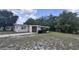 Single story home featuring neutral paint, an attached carport, and a concrete driveway at 2422 Kingsland Ave, Orlando, FL 32808