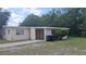Single story home featuring neutral paint, an attached carport, and a concrete driveway at 2422 Kingsland Ave, Orlando, FL 32808