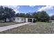Single story home featuring neutral paint, an attached carport, and a concrete driveway at 2422 Kingsland Ave, Orlando, FL 32808