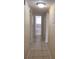 Hallway featuring neutral paint color, tile flooring, and white trim at 2422 Kingsland Ave, Orlando, FL 32808