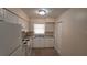 Kitchen featuring white cabinets, granite countertops, and white appliances at 2422 Kingsland Ave, Orlando, FL 32808